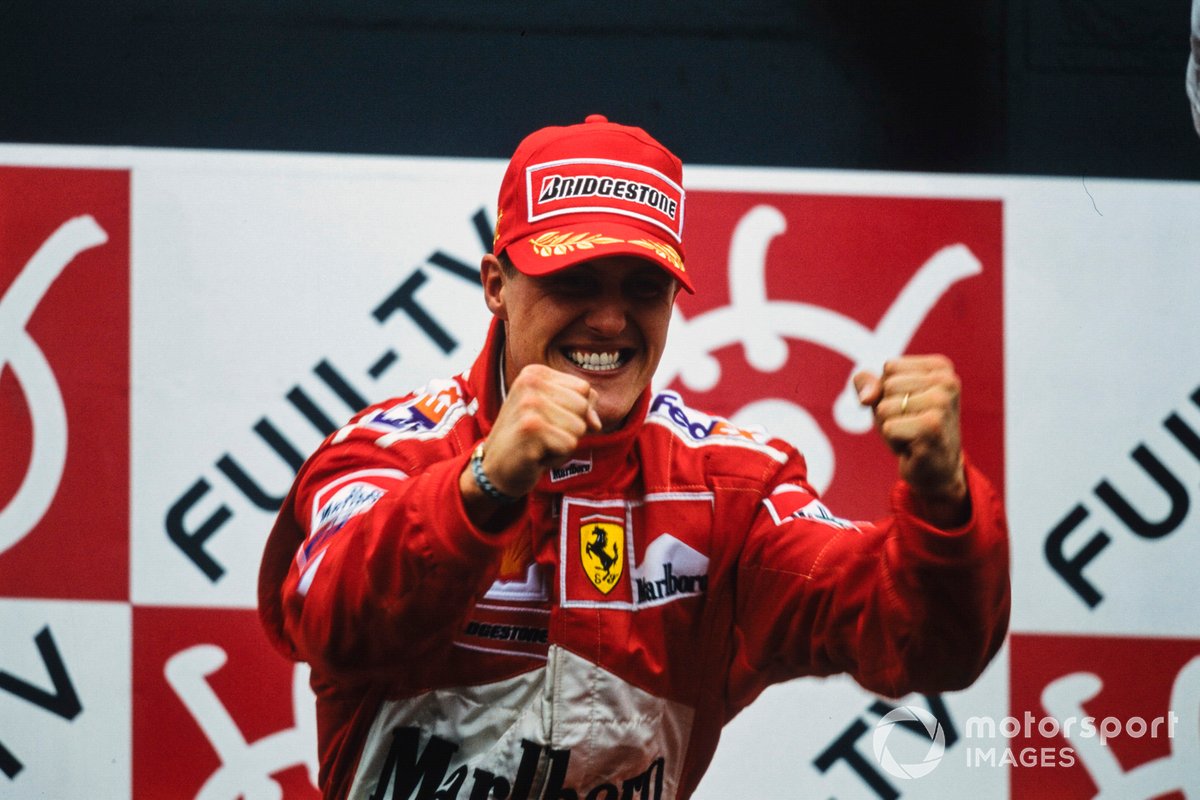 Michael Schumacher, 1st position, celebrates victory and securing his third drivers' title on the podium