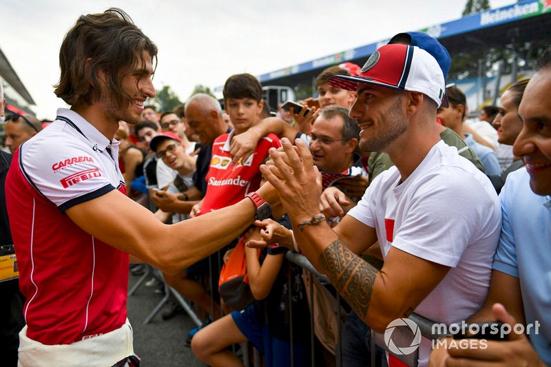 Antonio Giovinazzi, Alfa Romeo Racing signs his hat that he has just given to a fan