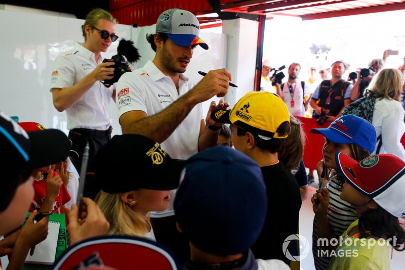 Carlos Sainz Jr., McLaren, signs autographs for young fans