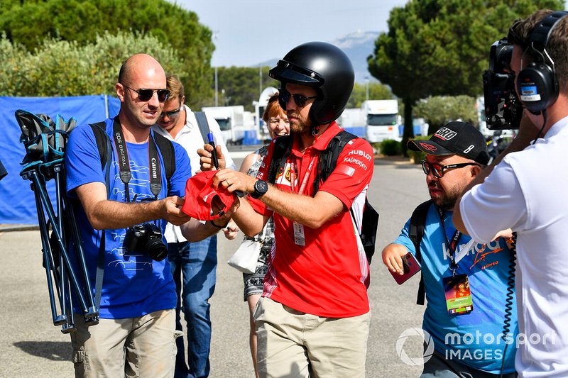 Sebastian Vettel, Ferrari signs a autograph for a fan 