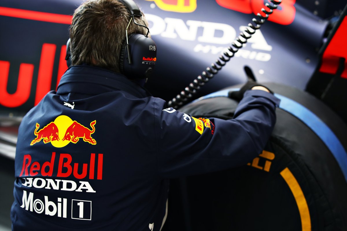 A member of the Red Bull Racing team works in the garage