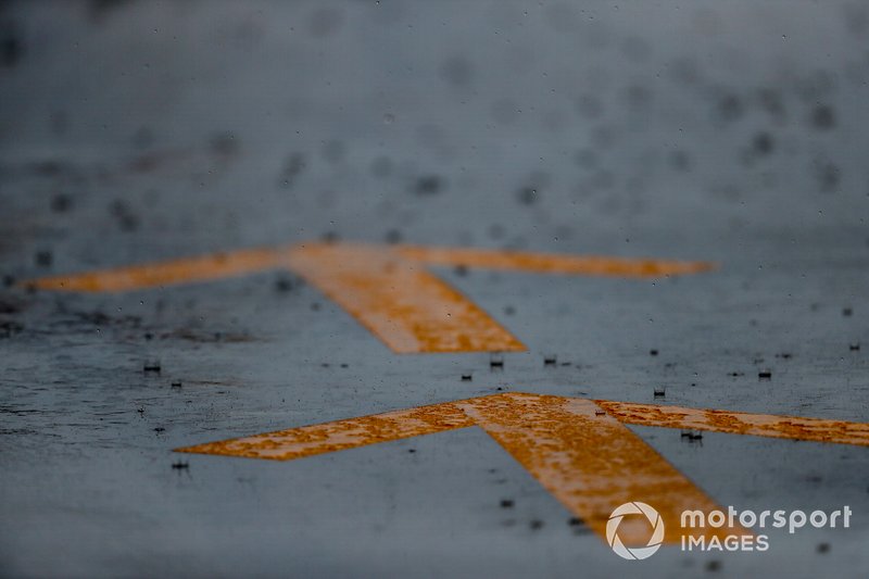 Rain falls on pit lane markings