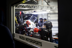 Mechanics working on the car of #70 Mazda Motorsports Mazda DPi: Joel Miller, Tom Long, James Hinchcliffe
