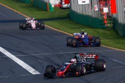 Romain Grosjean, Haas F1 Team VF-17, leads Carlos Sainz Jr., Scuderia Toro Rosso STR12, and Sergio P