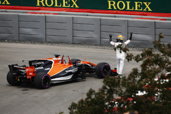 Fernando Alonso, McLaren, waves to the crowd after encountering technical trouble in FP1