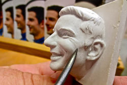 Sculptor William Behrends adds finer details to the ceramic likeness of 2016 Indianapolis 500 winner Alexander Rossi's image before it is cast in sterling silver