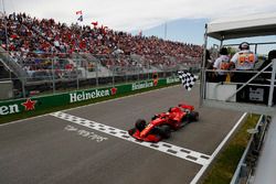 Sebastian Vettel, Ferrari SF71H, takes the chequered flag at the finish