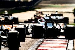 Romain Grosjean, Haas F1 Team VF-18 Ferrari, pulls across ahead of Fernando Alonso, McLaren MCL33 Renault