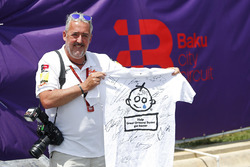 Mark Sutton, F1 Photographer with a signed Great Ormond Street T-shirt