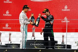 (L to R): Race winner Nico Rosberg, Mercedes AMG F1 celebrates with the champagne on the podium with third placed Sergio Perez, Sahara Force India F1