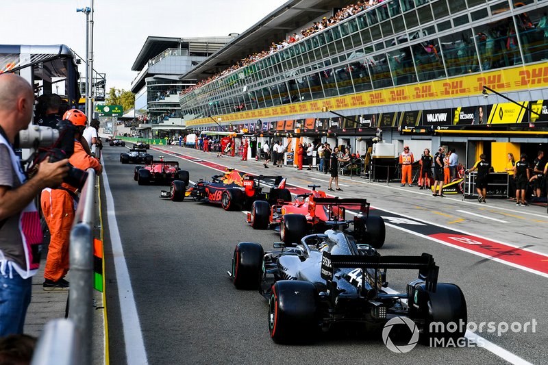 Charles Leclerc, Ferrari SF90, leads Alex Albon, Red Bull RB15, Sebastian Vettel, Ferrari SF90, and Lewis Hamilton, Mercedes AMG F1 W10, out of the pits