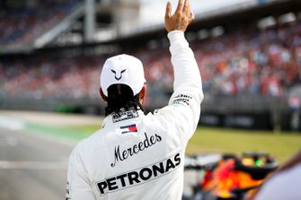 Lewis Hamilton, Mercedes AMG F1, waves to fans after securing pole