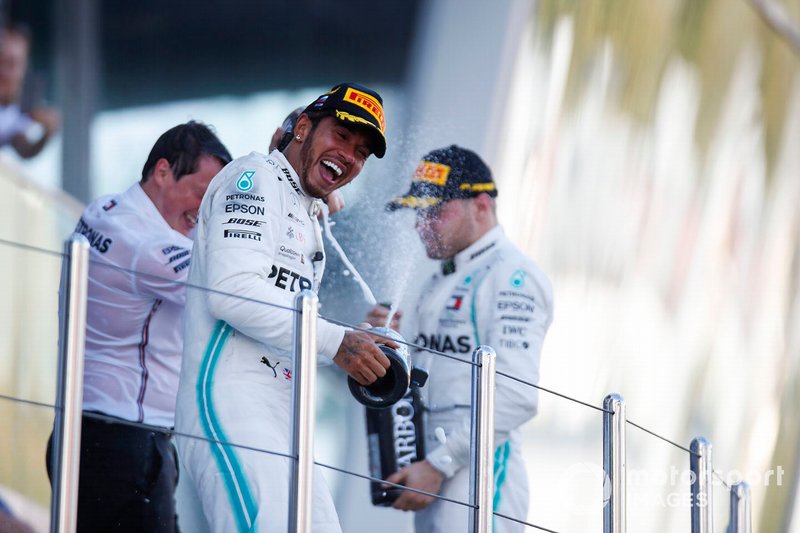 Lewis Hamilton, Mercedes AMG F1, 1st position, and Valtteri Bottas, Mercedes AMG F1, 2nd position, celebrate on the podium
