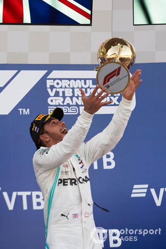 Lewis Hamilton, Mercedes AMG F1, 1st position, throws his trophy up in celebration