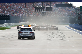 The Medical Car follows as the grid heads towards the first corner