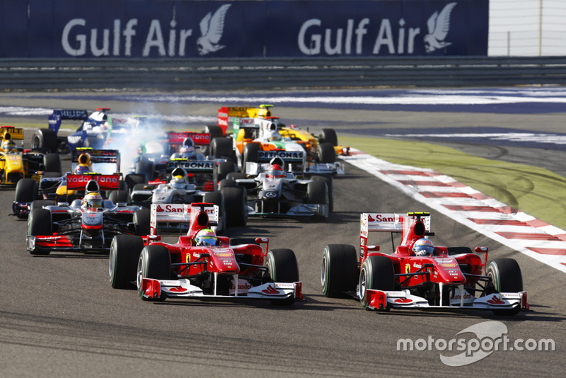 Fernando Alonso, Ferrari F10 passes team mate Felipe Massa, Ferrari F10 on the first lap of the race