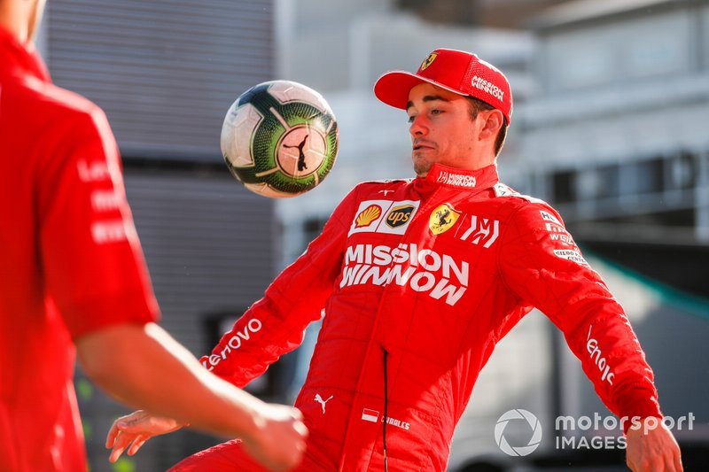 Charles Leclerc, Ferrari, plays football in the paddock