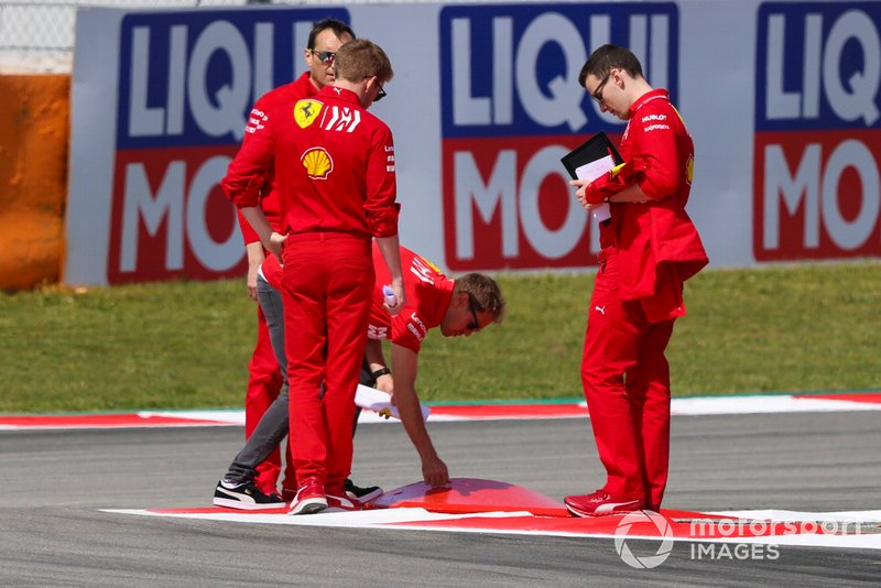 Sebastian Vettel, Ferrari, inspects a kerb