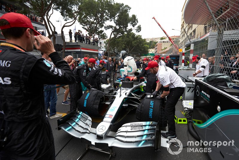 Mechanics prepare the car of Valtteri Bottas, Mercedes AMG W10, on the grid as he climbs out
