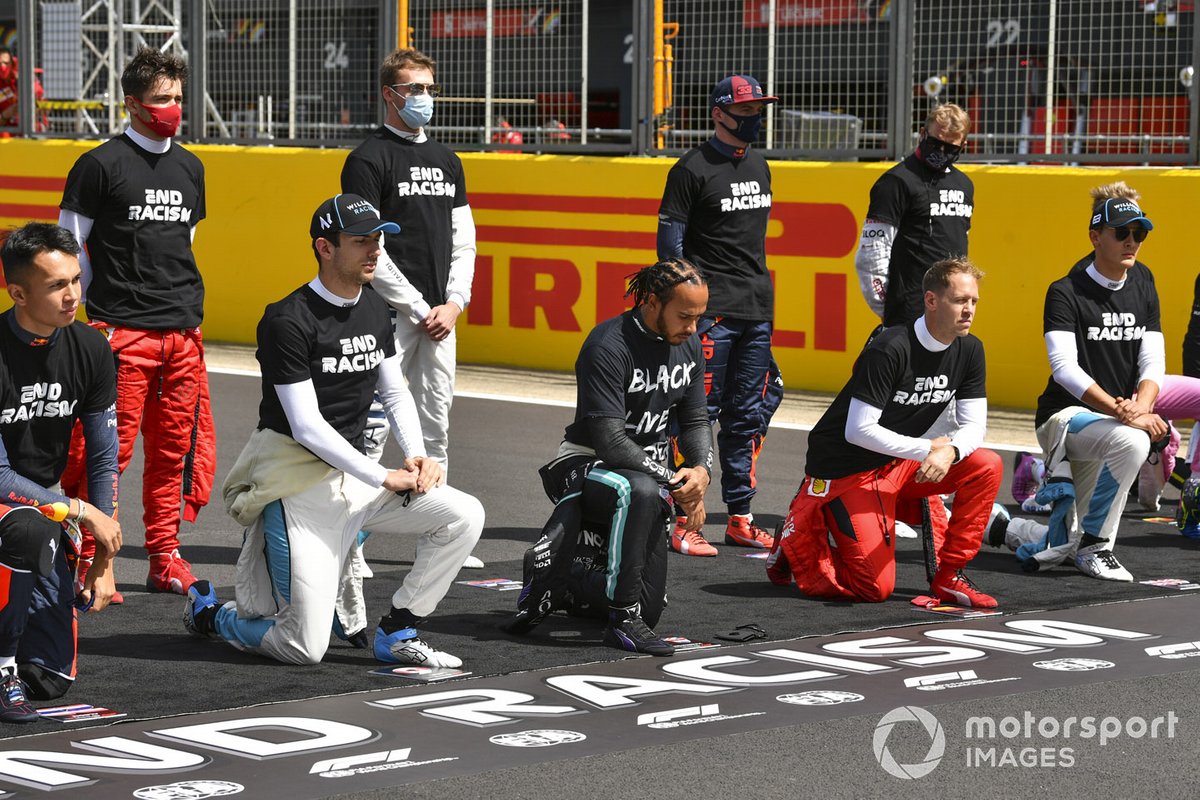 Lewis Hamilton, Mercedes-AMG F1, and the other drivers stand and take a knee to show their support for the End Racism campaign