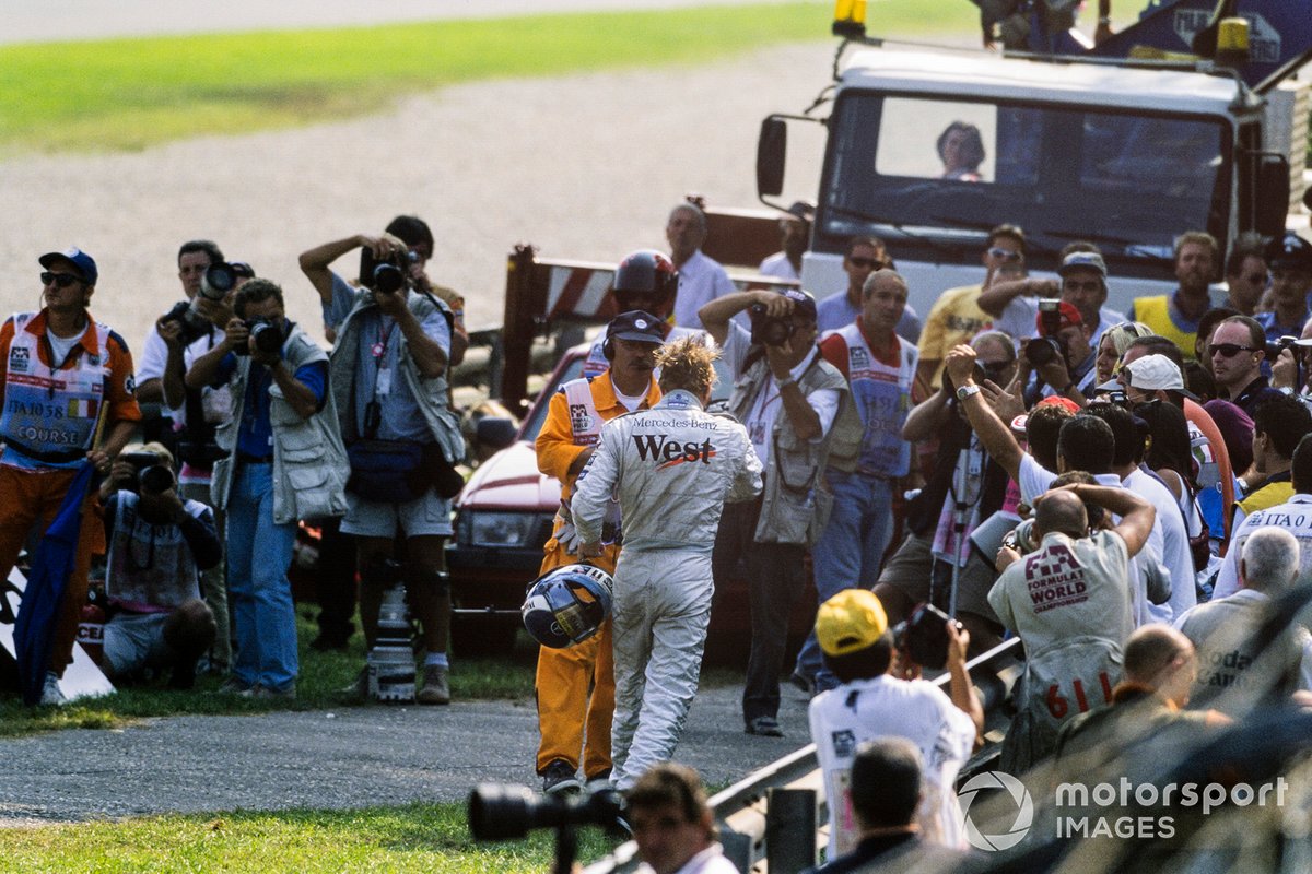 Mika Hakkinen,  McLaren MP4/14-Mercedes, walks away from his car