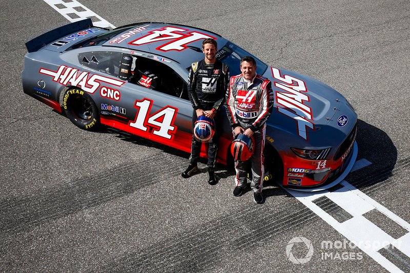 Romain Grosjean, Haas F1 Team Team, and Tony Stewart pose with a NASCAR