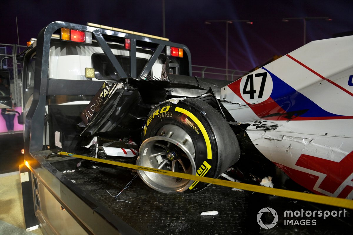 The damaged car of Mick Schumacher, Haas VF-21, is returned to the pits on a truck