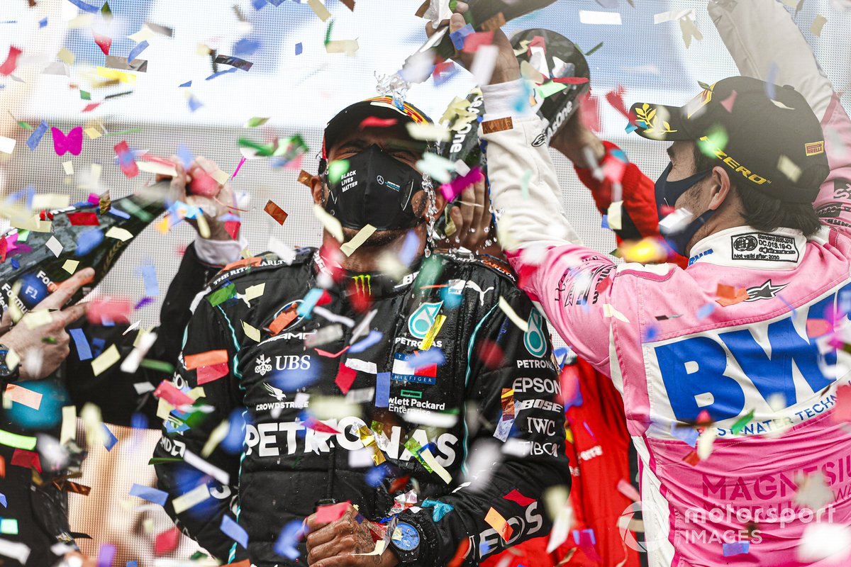 Sebastian Vettel, Ferrari, 3rd position, and Sergio Perez, Racing Point, 2nd position, pour Champagne over Lewis Hamilton, Mercedes-AMG F1, 1st position, on the podium