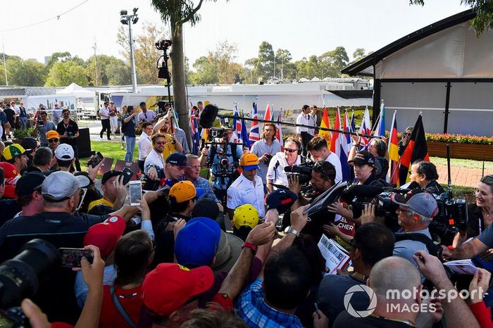 Lando Norris, McLaren, and Carlos Sainz Jr., McLaren, signs autographs for fans