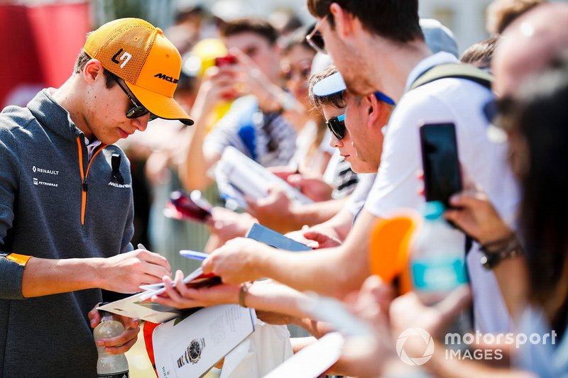 Lando Norris, McLaren, signs autographs for fans