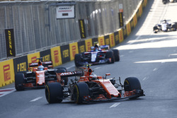 Stoffel Vandoorne, McLaren MCL32, leads Fernando Alonso, McLaren MCL32, and Carlos Sainz Jr., Scuderia Toro Rosso STR12