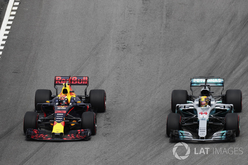 Max Verstappen, Red Bull Racing RB13, passes Lewis Hamilton, Mercedes AMG F1 W08, for the lead