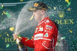 Sebastian Vettel, Ferrari, 1st Position, blasts himself with Champagne on the podium
