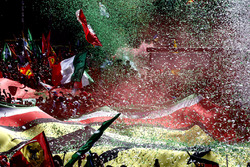 Confetti falls around the huge crowd of Ferrari fans gathered for the podium ceremony
