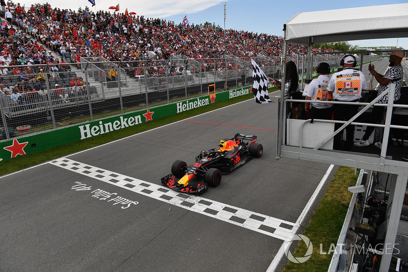 Max Verstappen, Red Bull Racing RB14 takes the chequered flag waved by Winnnie Harlow (CDN)