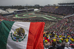 Fernando Alonso, McLaren MCL32 and fans in the grandstand with a Mexican flag