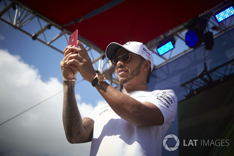 Lewis Hamilton, Mercedes AMG F1, takes a photo of the crowd