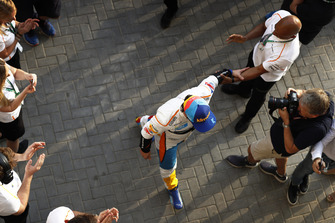 Fernando Alonso, McLaren, walks into the garage to the cheers of his team