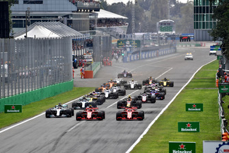 Sebastian Vettel, Ferrari SF71H and Kimi Raikkonen, Ferrari SF71H lead at the start of the race