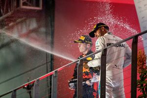 Max Verstappen, Red Bull Racing, 2nd position, and Lewis Hamilton, Mercedes AMG F1, 1st position, spray Champagne on the podium