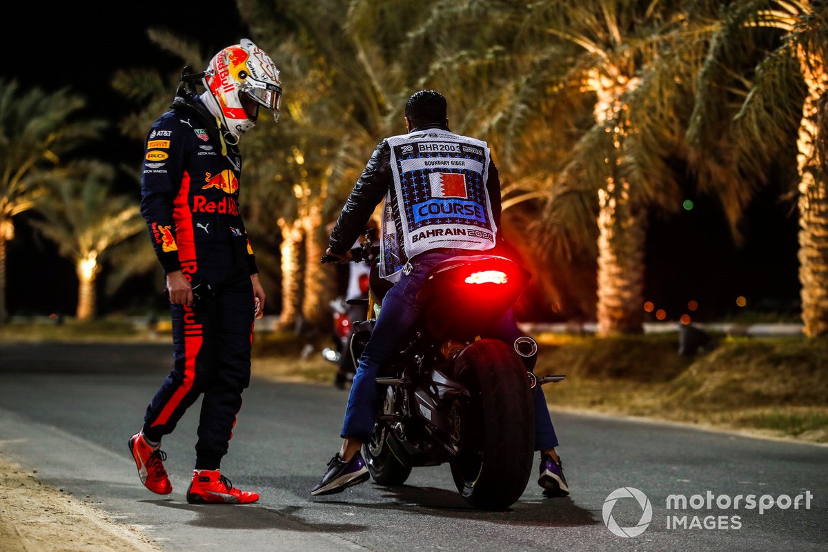 Max Verstappen, Red Bull Racing, gets on a course motorcycle after retiring