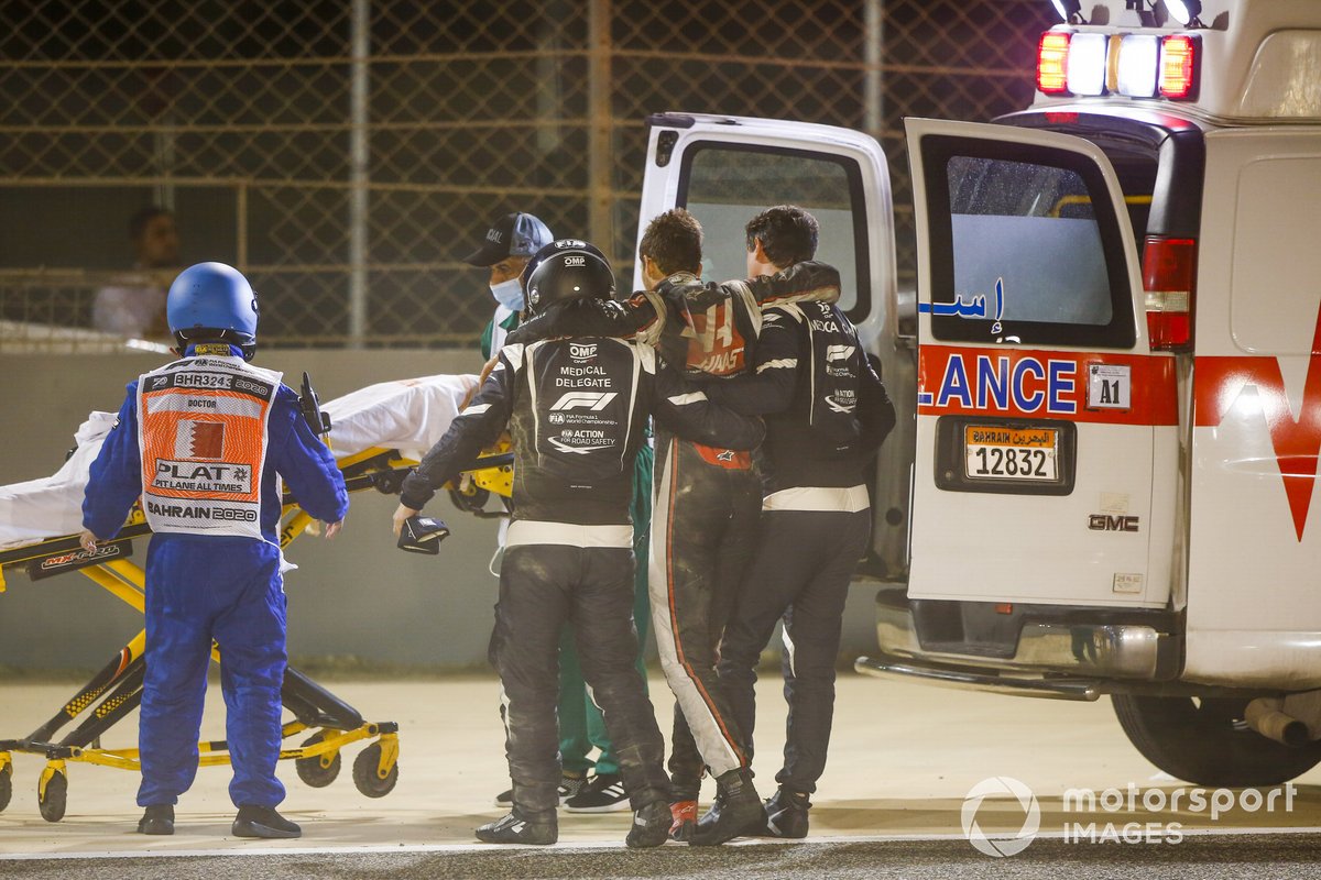 Medical delegates assist Romain Grosjean, Haas F1, after a huge crash on the opening lap