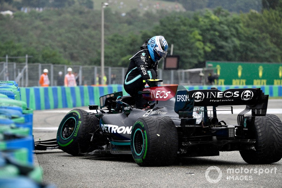 Valtteri Bottas, Mercedes W12, climbs out of his damaged car after crashing out at the start