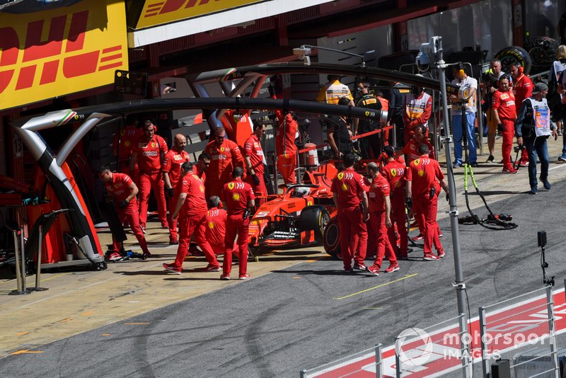 Sebastian Vettel, Ferrari SF90, is returned to the garage