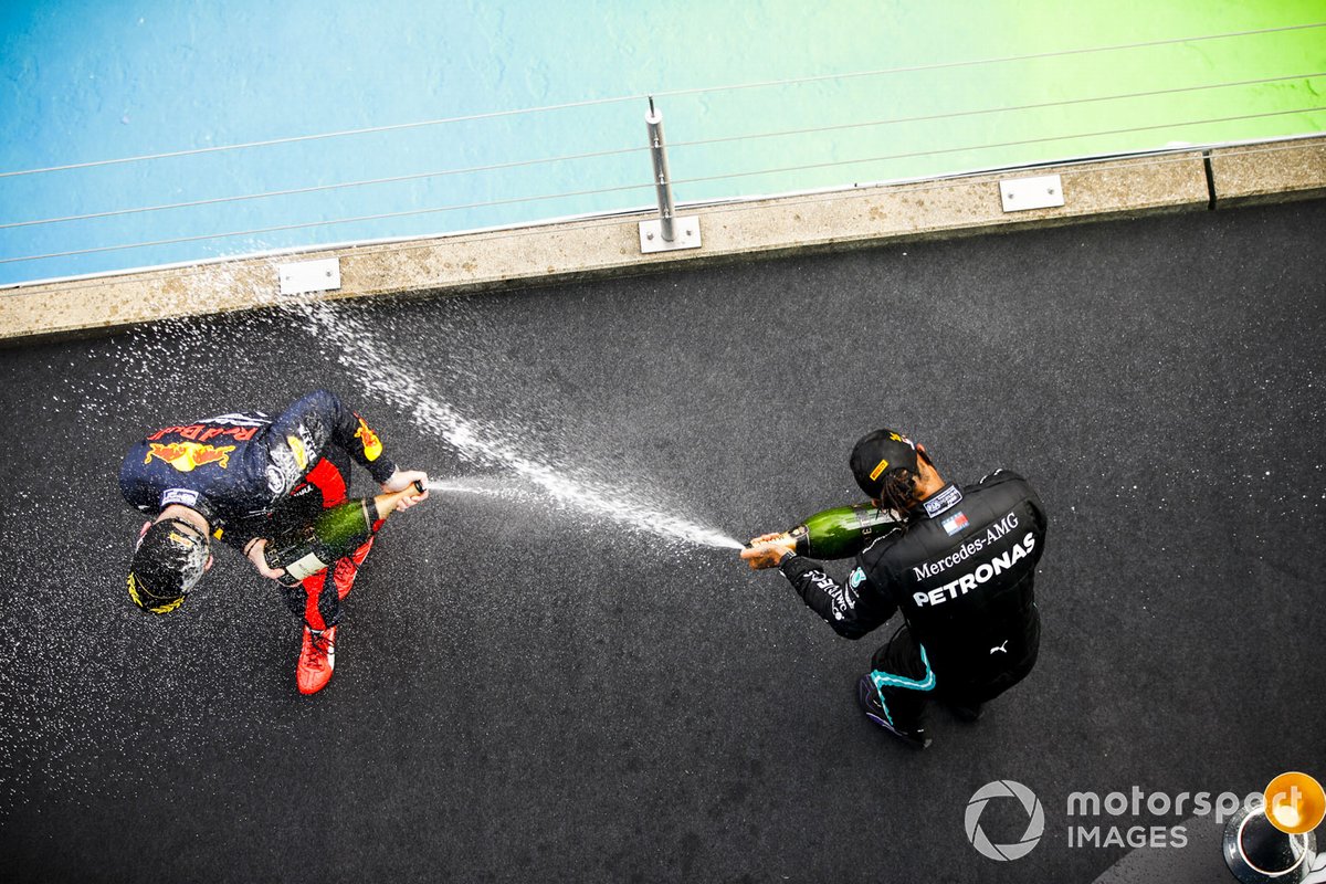 Max Verstappen, Red Bull Racing and Race Winner Lewis Hamilton, Mercedes-AMG F1 celebrates on the podium with the chamapgne