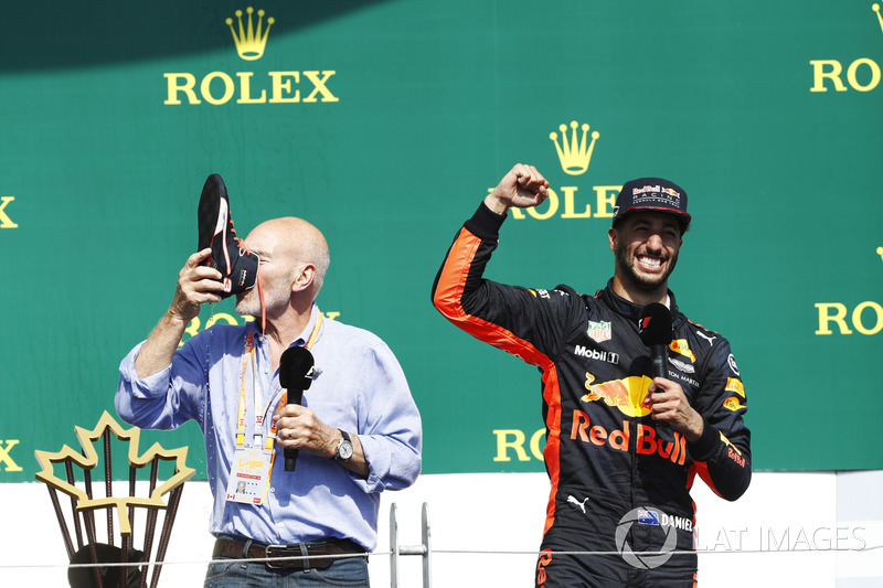 Sir Patrick Stewart drinks champagne from the shoe of Daniel Ricciardo, Red Bull Racing, on the podium