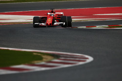 Kimi Raikkonen, Ferrari SF70H, lifts a wheel over a kerb
