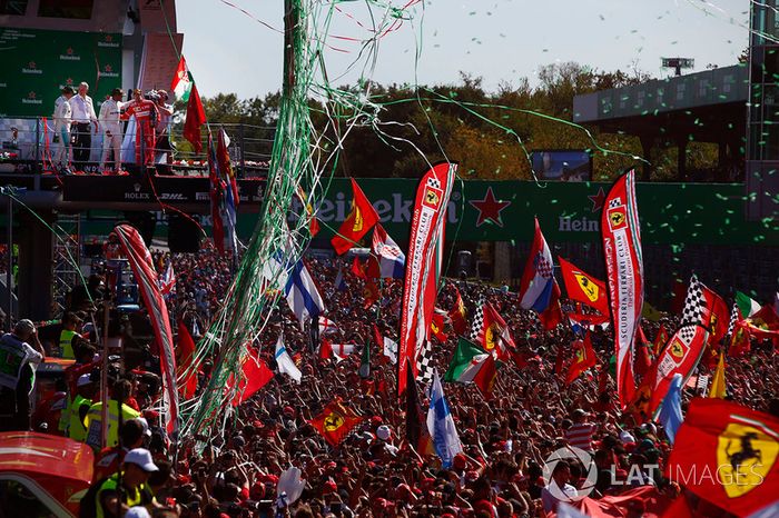 Confeti cae alrededor de la multitud de fans de Ferrari que se reunieron para la ceremonia de podio