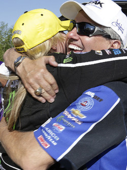 Top Fuel winner Brittany Force gets a hug from her father John Force