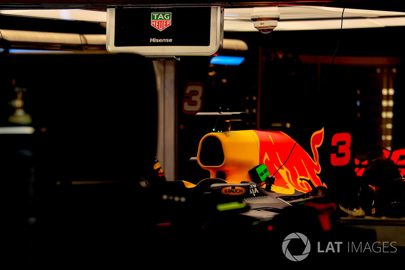 The car of Daniel Ricciardo, Red Bull Racing RB13 is worked on by mechanics in the garage
